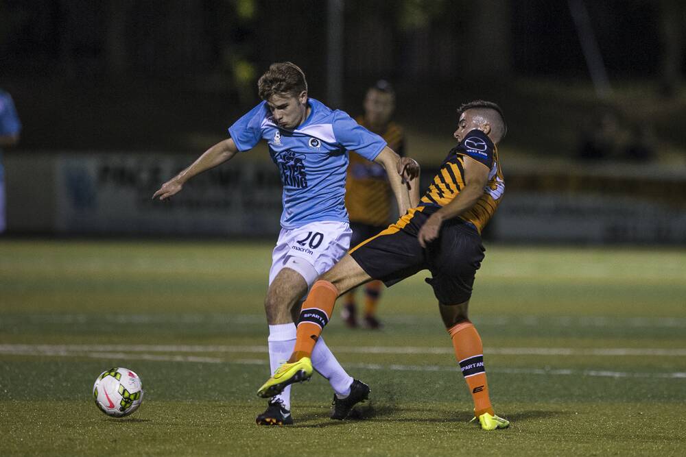 Winning start: Sutherland Sharks FC fullback Mitchell Farmer challenges for the ball against Blacktown Spartans FC on Saturday at Seymour Shaw Park. Picture: Football NSW