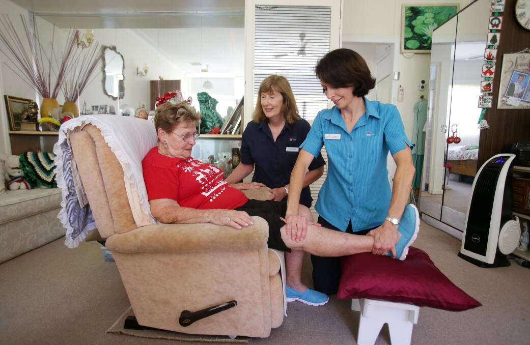 Sitting comfortable: SOS client Dorothy Hippit with Southcare registered nurse Linden Harper and physiotherapist Michelle Sullivan. Picture: Chris Lane