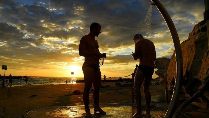 Swimmers rinse off at Clovelly Beach before the temperatures rise in Sydney on Tuesday morning. Photo: Kate Geraghty