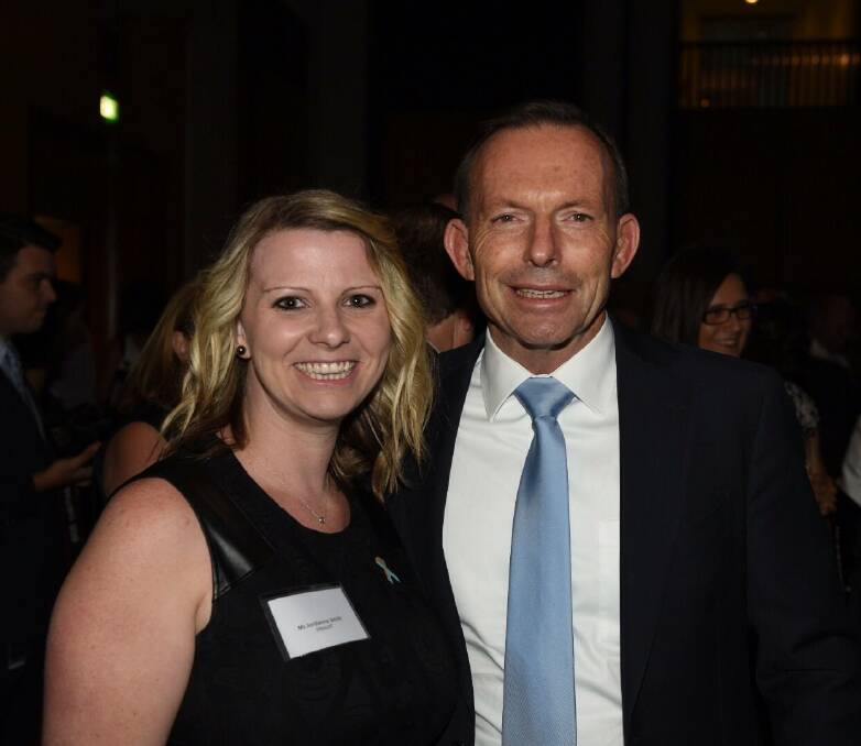 Helping the deaf: Prime Minister Tony Abbott congratulates Jordanna Smith on her award.

