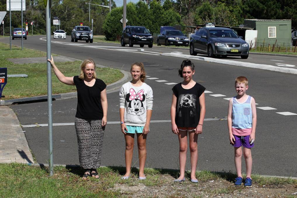 Time to act: The school community, including Menai parent Paula Collins with Bec, Mia and Evan, awaits funding to make its mark at dangerous stretch of road. Picture: John Veage