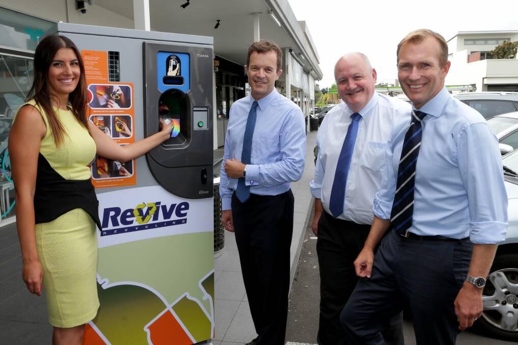 Litter problem: Environment Minister Rob Stokes promotes a proposed reverse vending machine scheme to collect cans and bottles in public places, with Liberal candidates Eleni Petinos, Mark Speakman and Lee Evans. Picture: Jane Dyson