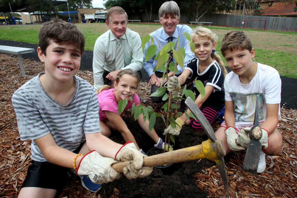 It's easy being green: School students James Martin, Neve Barnsley, Aurora Aiello and Jack Dixon from St Patrick's Primary School at Sutherland planted saplings outside their school to help maintain the shire's tree canopy. They are pictured with mayor Steve Simpson and principal Phillip Tax. Picture: Jane Dyson