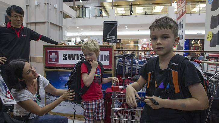Owen and Toby Street with their mother Jane shopping for new backpacks. Photo: Sahlan Hayes
