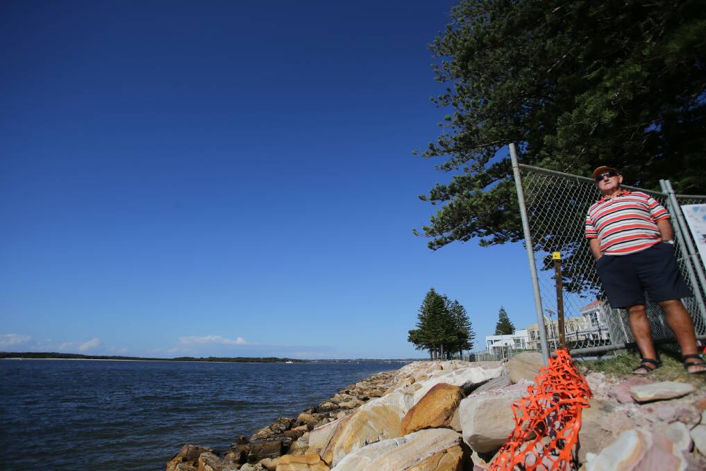 Just in time: Ed Parker, of Sans Souci,checks out the restored wall in Sandringham Bay, which was largely finished before the recent big storm. Picture: Chris Lane
