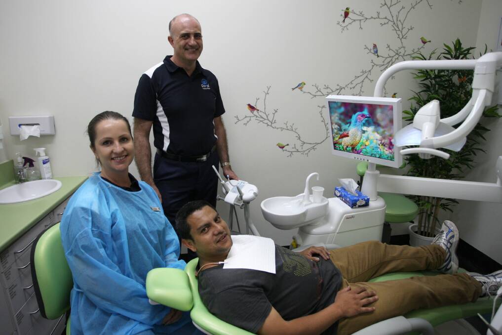 All smiles: Galo Caballero is treated as part of the initiative supported by Word of Mouth Dentistry manager Eric Willma and dentist Tracey Mirarchi.Picture: Sam Venn