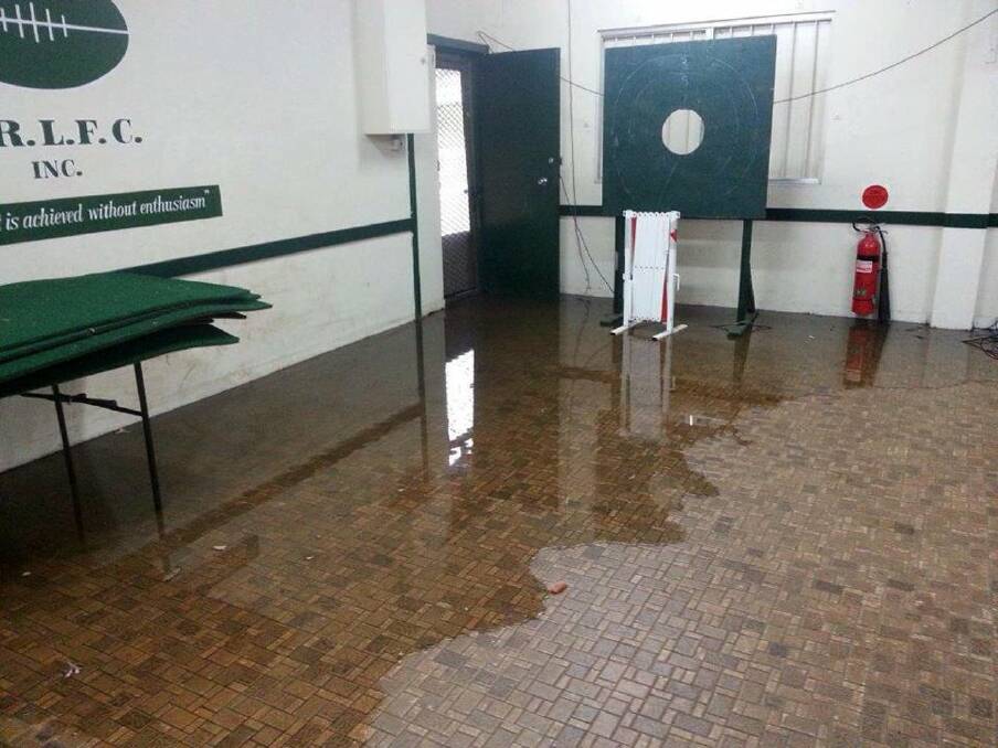 Under water: The clubhouse at Scylla Oval, Como, floods after heavy rain.