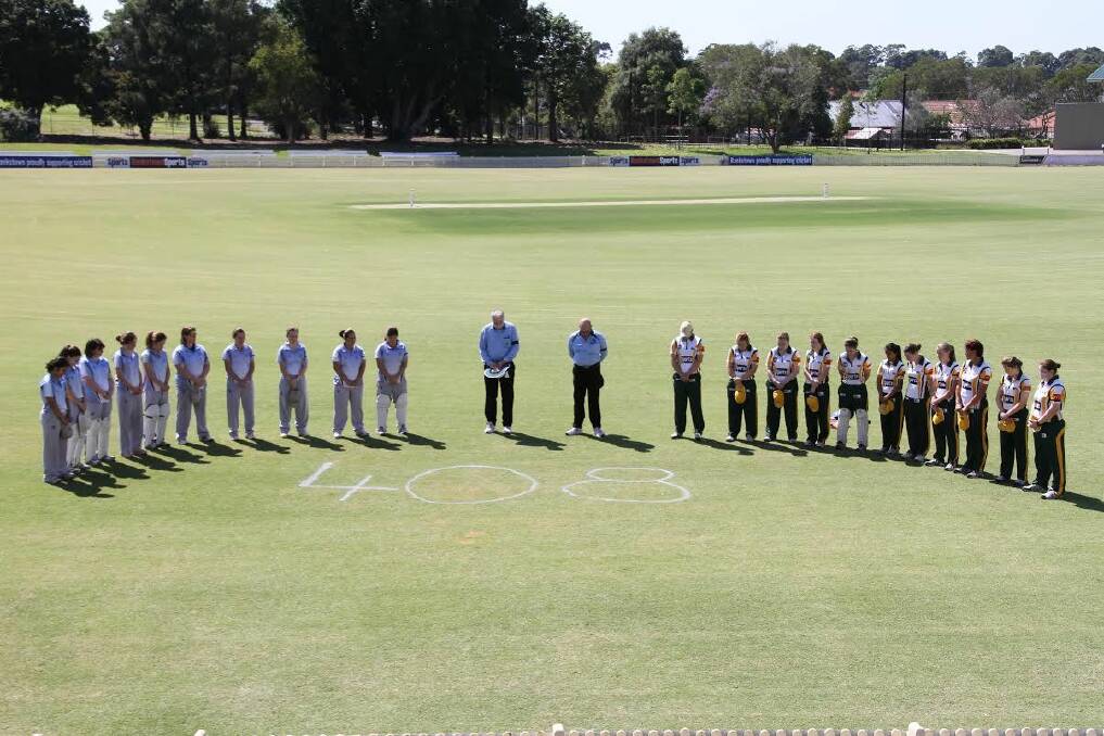 Showing their support: St George-Sutherland women's first grade cricket team and Bankstown players observing a minute's silence for Phillip Hughes at Bankstown Oval on Sunday.