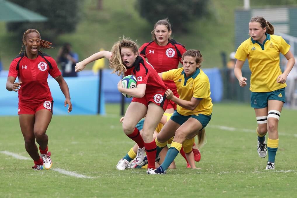 Gold medal girl: Brooke Anderson tackling Canada in Australia's 38-10 Youth Olympics rugby union sevens win in China. Picture: Suhaimi Abdullah, Getty Images