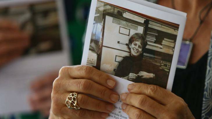 A woman holds a copy of the service order at the funeral for Adele Horin. Photo: Daniel Munoz