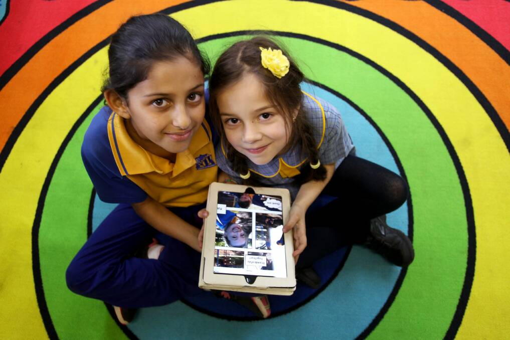 Happy to help: Junior and senior pupils, including Claudia Salami and Isabella Lushinovska, work together in the digital sphere. Picture: Jane Dyson