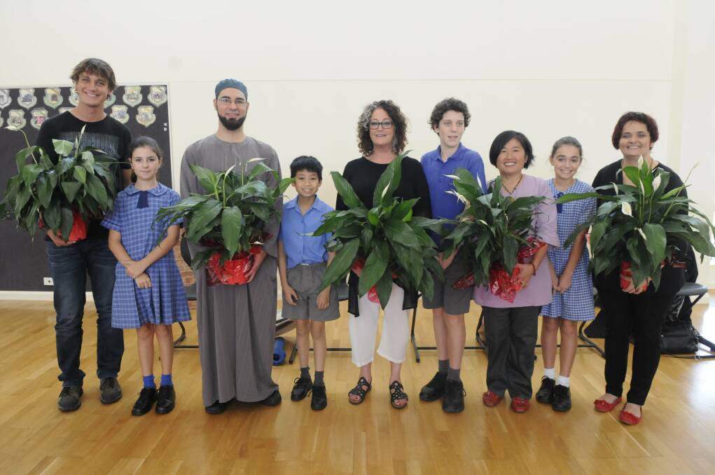 Harmonious: Interfaith guest speakers with primary school pupils at the special Harmony Day event.