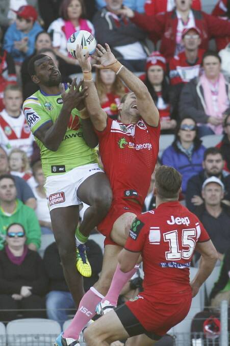 Airborne (left): Dragons winger Jason Nightingale takes a high kick against the Raiders at Wollongong. Picture: Christopher Chan
