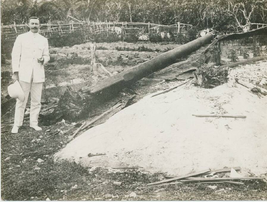 TENNIS COURT UNDAMAGED: The wireless operator who sent the SOS call that brought HMAS Sydney to the area, standing next to the wireless mast destroyed by the German raiding party from the Emden. Photo: Argus Collection, Fairfax Photographic 