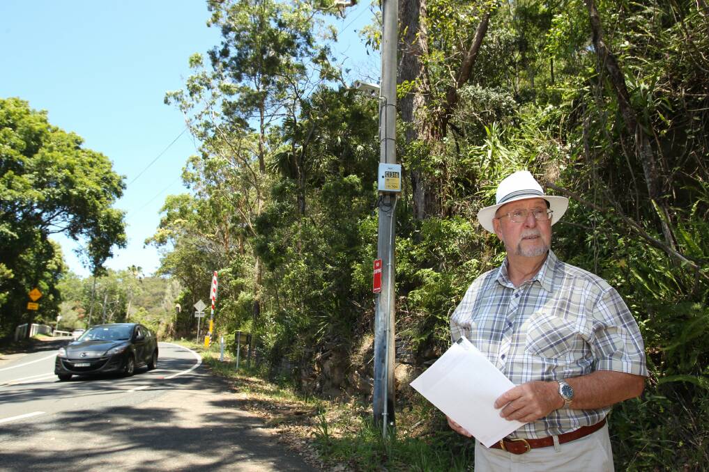 Early warning: Wayne King, vice president of Bundeena Progress Association, below one of the new cameras, which provides early warning advice on when the weir roadway is closed. Picture: Chris Lane