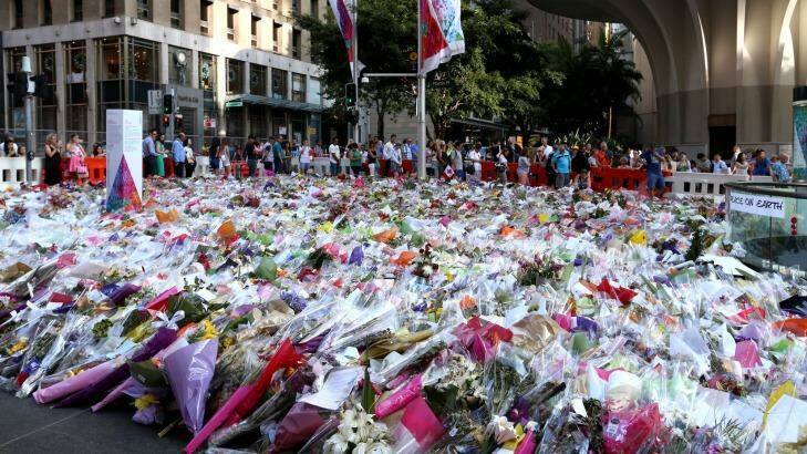 People line up to leave their flowers at Martin Place.  Photo: James Alcock