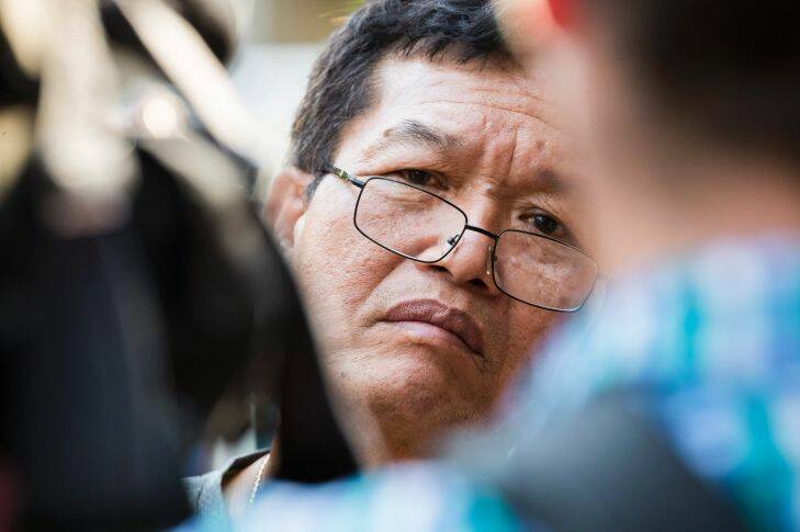 Friend, of the victim, Van Nguyen, 59, speaks to media as police work a crime zone after a reported shooting in the Bankstown CBD in front of Happy Cup Cafe. Photo by Cole Bennetts