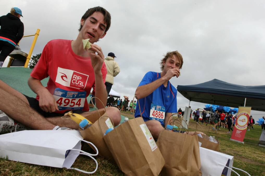 Tucking in: These youngsters were hungry after they completed the 11-kilometre course and made the finish line on Sunday in the successful Sutherland2Surf Fun Run and Walk. Almost 8000 competitors took part. Picture John Veage