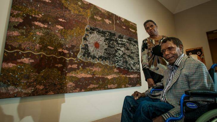 Artist Clifford Possum Tjapaltjarra's children Gabriella, from Melbourne, and Lionel Possum, from Alice Springs, see their father's work "Warlugulong" at the National Gallery of Australia. Photo: Elesa Kurtz