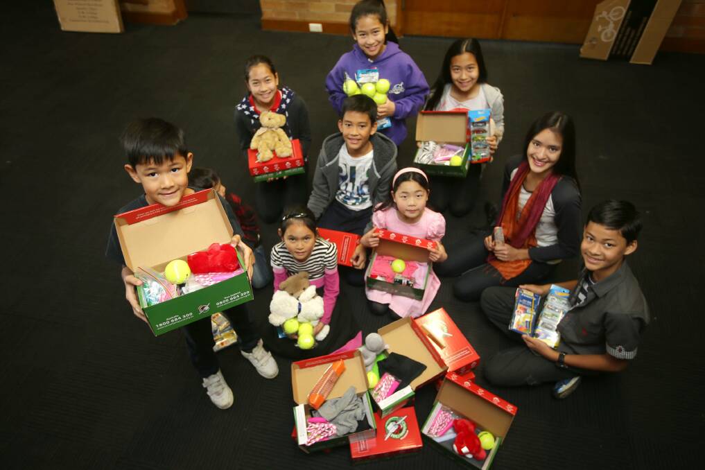 Hope they like this: Hurstville kids fill up gift boxes. Picture: John Veage
