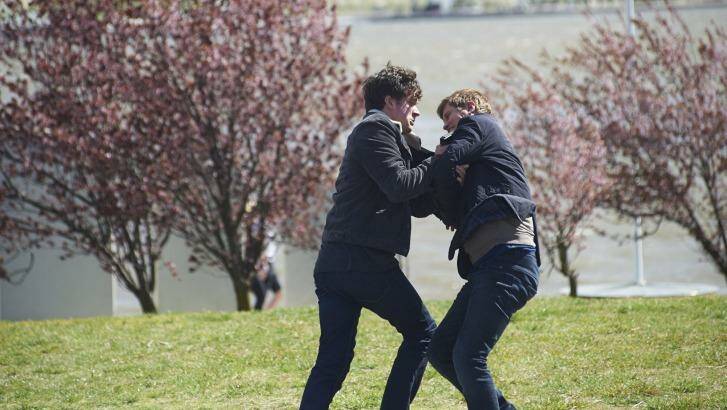 ABC TV political thriller The Code will return for a second season. Hacker Jesse Banks, played by Ashley Zukerman, wrestles with AFP officer Lyndon Joyce, Dan Wyllie, on the shores of Lake Burley Griffin.  Photo: Simon Cardwell