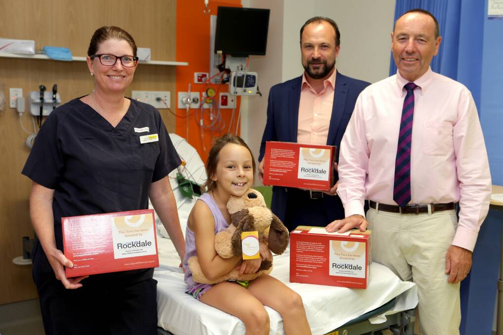 Making a difference: Associate Professor Kate Curtis, Rockdale City Ford dealer principal Jarrad Czapla and Day of Difference Foundation chief executive Charles Dennis present patient Lilly Snell, 8, with a Tara comfort toy. Picture: Jane Dyson