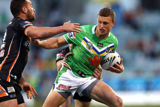 CANBERRA, AUSTRALIA - AUGUST 30:  Jack Wighton of the Raiders fends off the tackle of Bodene Thompson of the Tigers during the round 25 NRL match between the Canberra Raiders and the Wests Tigers at GIO Stadium on August 30, 2014 in Canberra, Australia.  (Photo by Renee McKay/Getty Images) Photo: Renee McKay