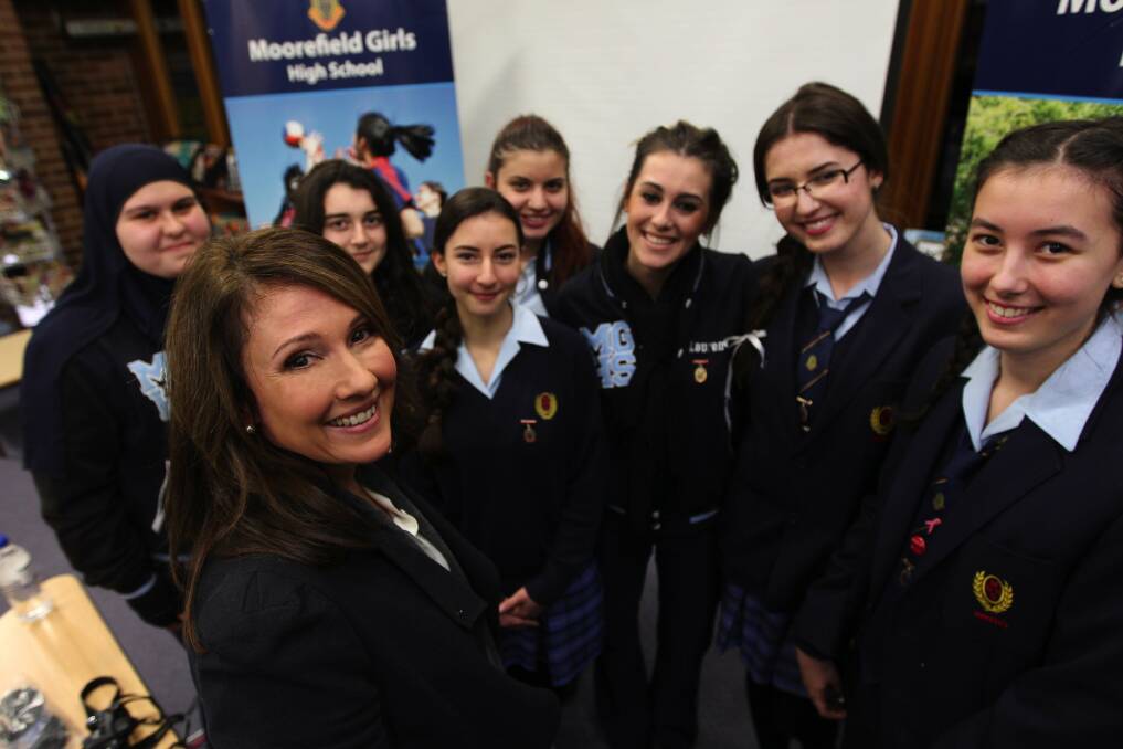School guest: Television news presenter Chris Bath with Moorefield Girls High School students. Picture: John Veage