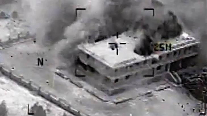 This still image made from video released by the U.S. Central Command on Tuesday, Sept. 23, 2014, shows a structure in Tall Al Qitar, Syria moments after a U.S. airstrike. In three waves of nighttime attacks launched over four hours early on Tuesday, the U.S. and its Arab partners made more than 200 airstrikes against roughly a dozen militant targets in Syria. (AP Photo/US Central Command) Photo: Uncredited
