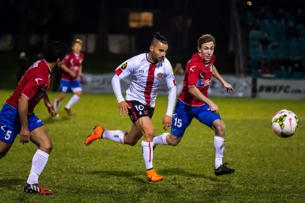 Up to the challenge: Rockdale City's Marko Jesic (C) battles for the ball with Bonnyrigg's Ray Miller on Saturday night. Picture: FootballNSW