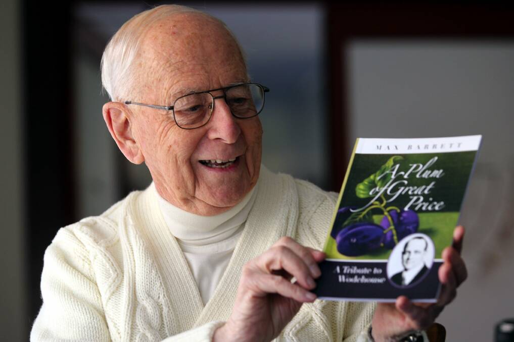 Priest and author: Father Max Barrett with his new book. Picture: John Veage