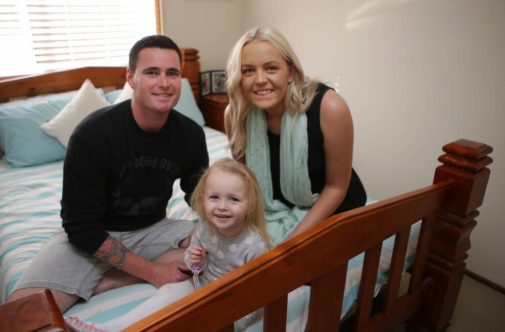 Good cause: Dean Ramsay will run the Gold Coast marathon on Sunday to raise funds for his daughter Chloe who has mitochondrial disease. He is shown with wife Michelle and child. Picture: John Veage