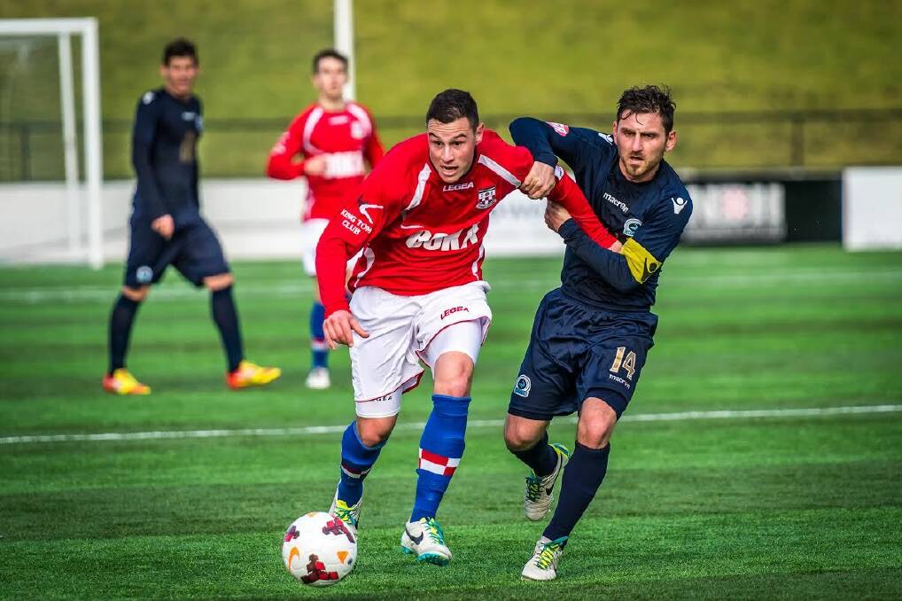 Tussle: Sydney United 58 Fc's Stejpan Paric (left) and Sutherland Sharks FC captain Nick Stavroulakis in the 3-3 draw on Sunday at Sydney United Sports Centre. Picture: Football NSW