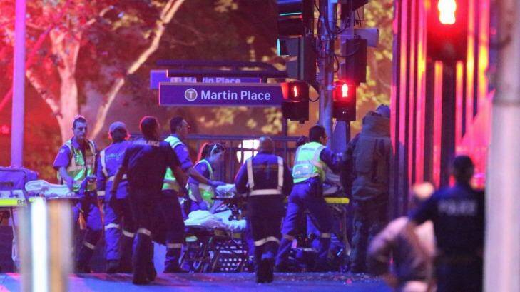 Ambulance officers move into the Lindt Chocolate Cafe as the siege comes to a dramatic end. Photo: Andrew Meares
