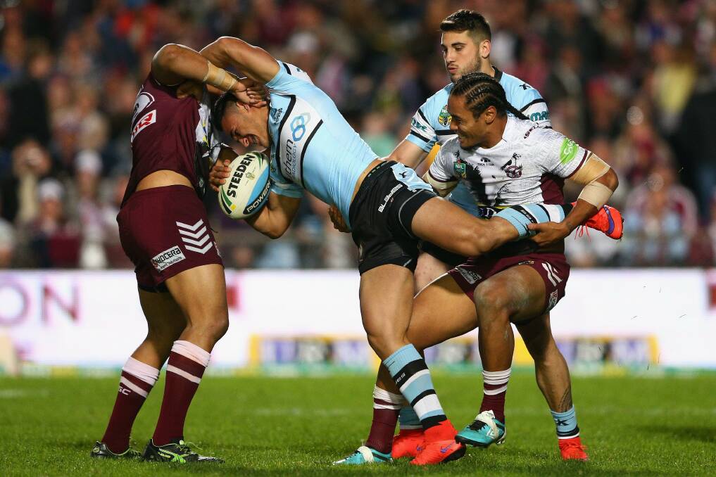 Tough going: Cronulla winger Valentine Holmes is tackled during the Sharks' loss to Manly. Picture: Cameron Spencer, Getty Images