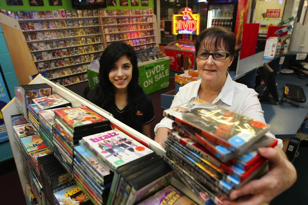 Defying the trend: Lillian Wilde (above right) with staff member Maddy at the Civic Video outlet at Cronulla and the Caringbah
store (below right) which closed on June 30. Pictures: John Veage
