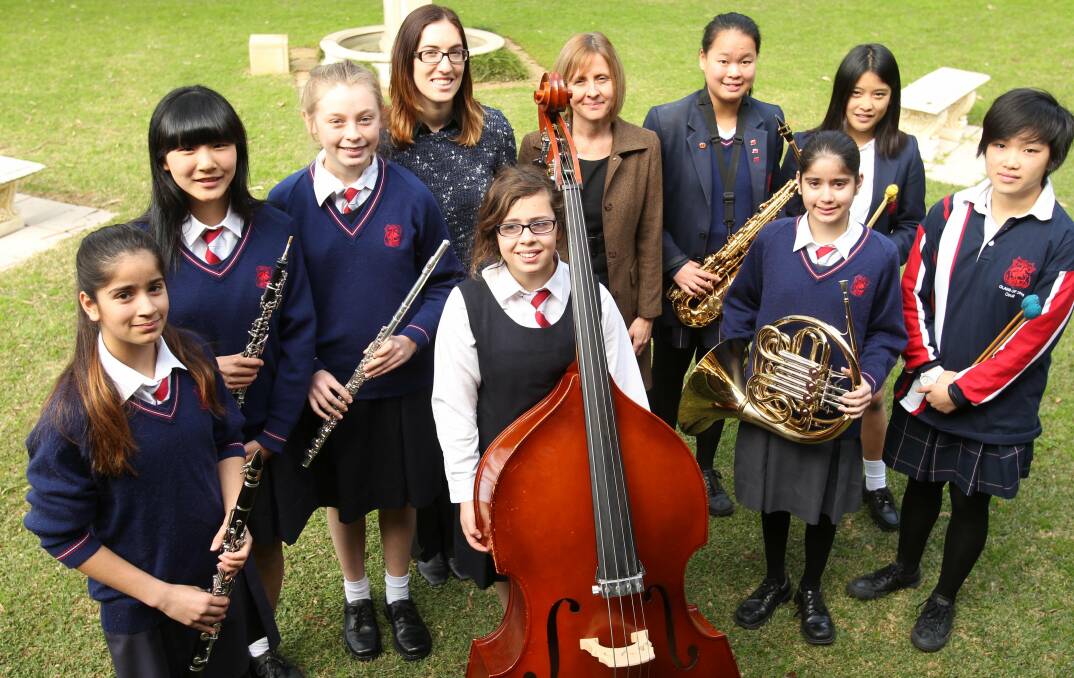 Global tunes: Talented music students from St George Girls High School are preparing for their overseas tour. They are with their teachers Ashley Hamilton and Sue Oyston. Picture: Chris Lane