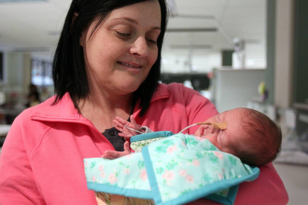 Mother's love: Belinda McNabb and baby Lilly Diaz, with one of the specially made quilts. Picture: Chris Lane