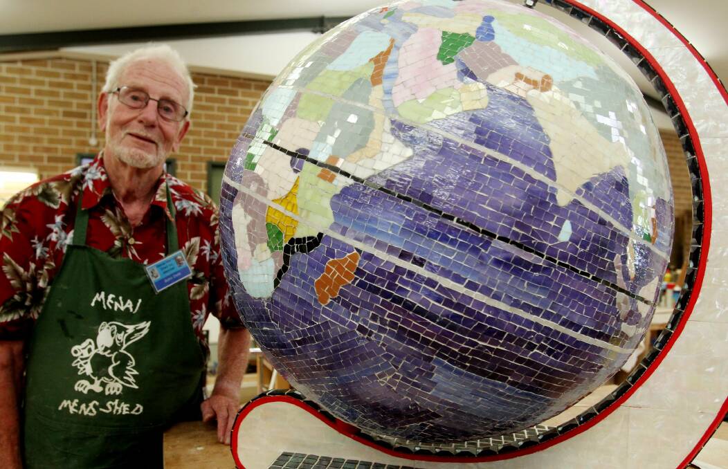 It’s a small world: John Osté with his mosaic-covered globe which took almost 2000 hours to complete using 30,000 individually cut pieces of glass. Picture: Chris Lane

