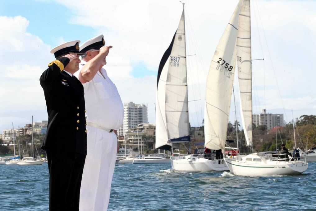 Ahoy there: Royal Australian Navy Commodore Michael Rothwell and Royal Motor Yacht Club Port Hacking Commodore Bob Lay take the salute from participants in the parade of sail last weekend. Picture: Jane Dyson