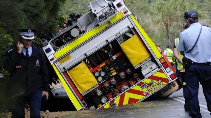 SMH NEWS: A fire truck sinks into a hole in the road created by a land a water leak in The Serpentine, Bilgola. 13/04/14  Phoot: Kristjan Porm