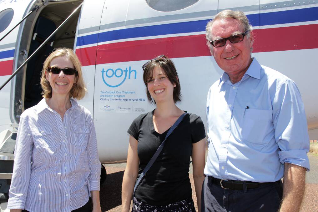 Philanthropist David Gonski AC, his wife Orli Wargon (left) and daughter Kate inspect an aircraft that carries staff of The Outback Oral Treatment and Health (TOOTH) program from Dubbo to rural and remote communities in Western NSW. 					 Photo: Contributed