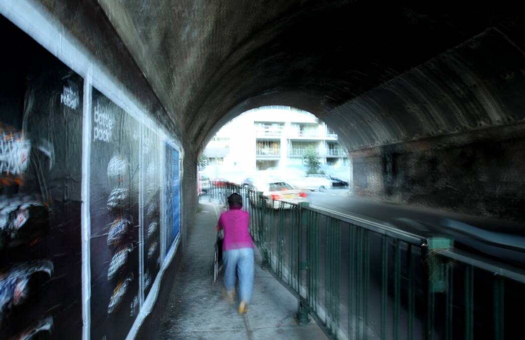 Tunnel trouble: A resident walk's  through the dangerous road tunnel on Wollongong Road, Arncliffe. Picture Chris Lane