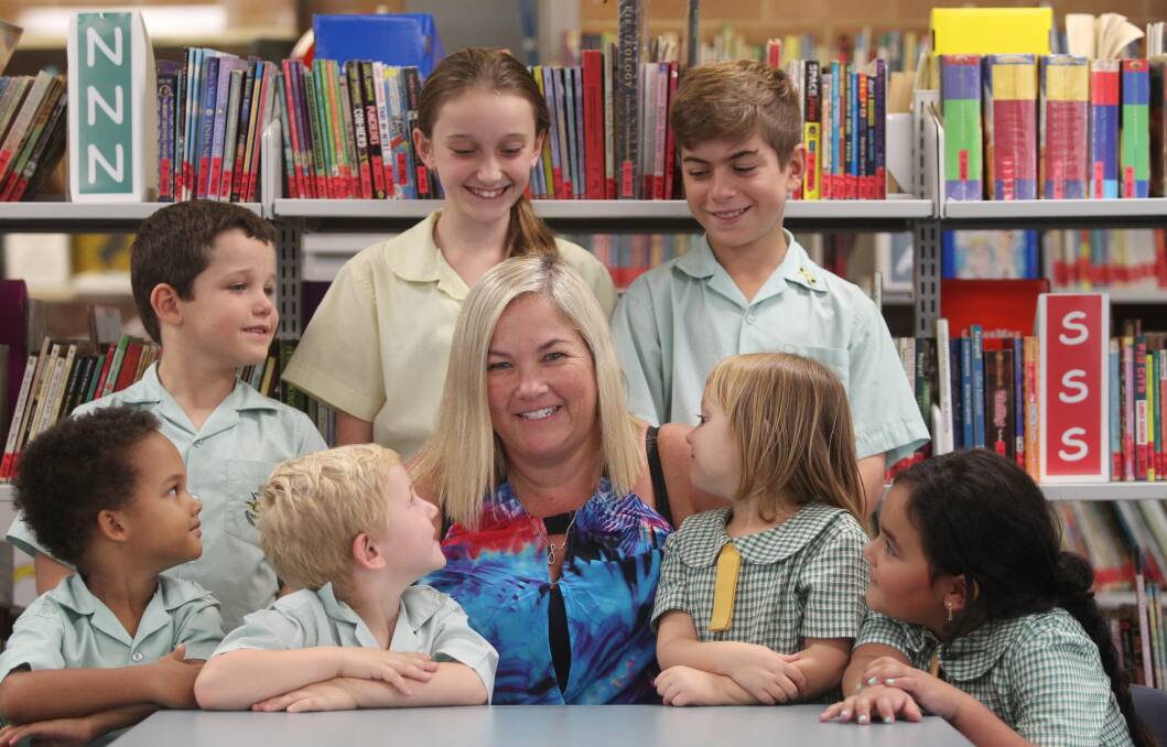 Love of teaching: Menai Public School's new leader Wanita Bowles ensures she gets time in the classroom alongside her duties as principal. She is pictured with pupils (back row) Callum Greentree, Ella Fuller, Lewis Holmewood and (front row) Karani Davies, Boyd Verus, Bethan Neale and Gizelle Joseph. Picture: Chris Lane