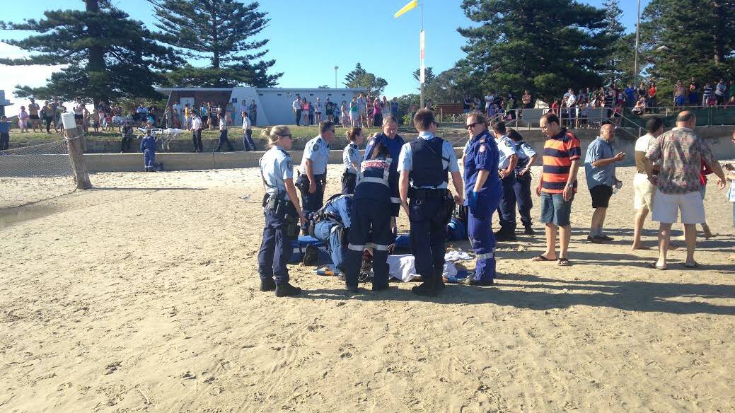 Near tragedy: Paramedics work to save a girl, 8, who was pulled unconscious from the water at Dolls Point yesterday. Picture: CareFlight.
