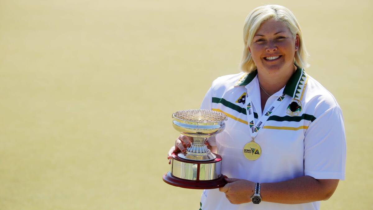 Winner grins: Katrina Wright with her Champion of Champions singles trophy at Taren Point Bowling Club. Picture: Chris Lane
