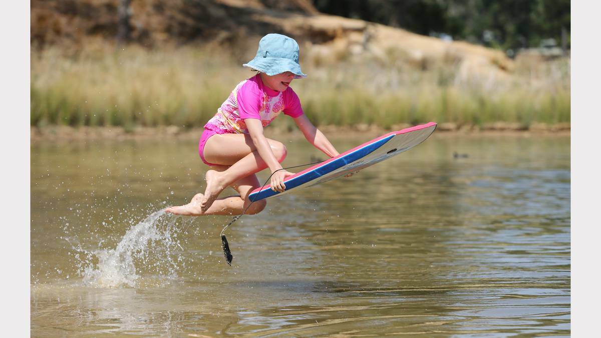 BORDER MAIL (Albury-Wodonga) - Clare Martinae, 7, takes a flying leap into the waters of Lake Sampbell, at Beechworth.