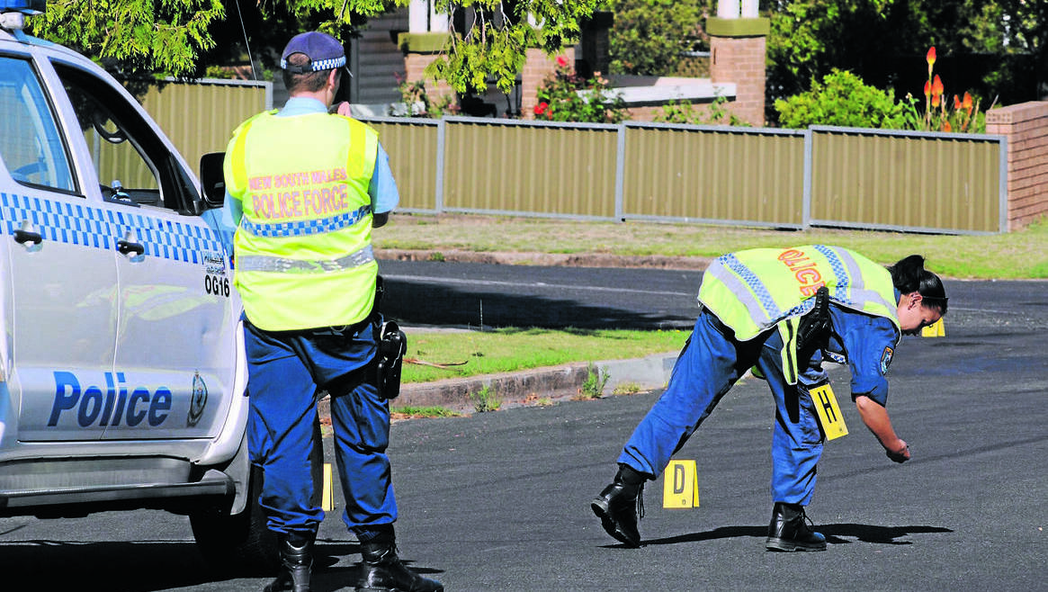 CENTRAL WESTERN DAILY (Orange) - A FORENSIC team establish a crime scene on the corner of Icely Road and Allenby Road after two people were allegedly shot at during a robbery. Photo: STEVE GOSCH