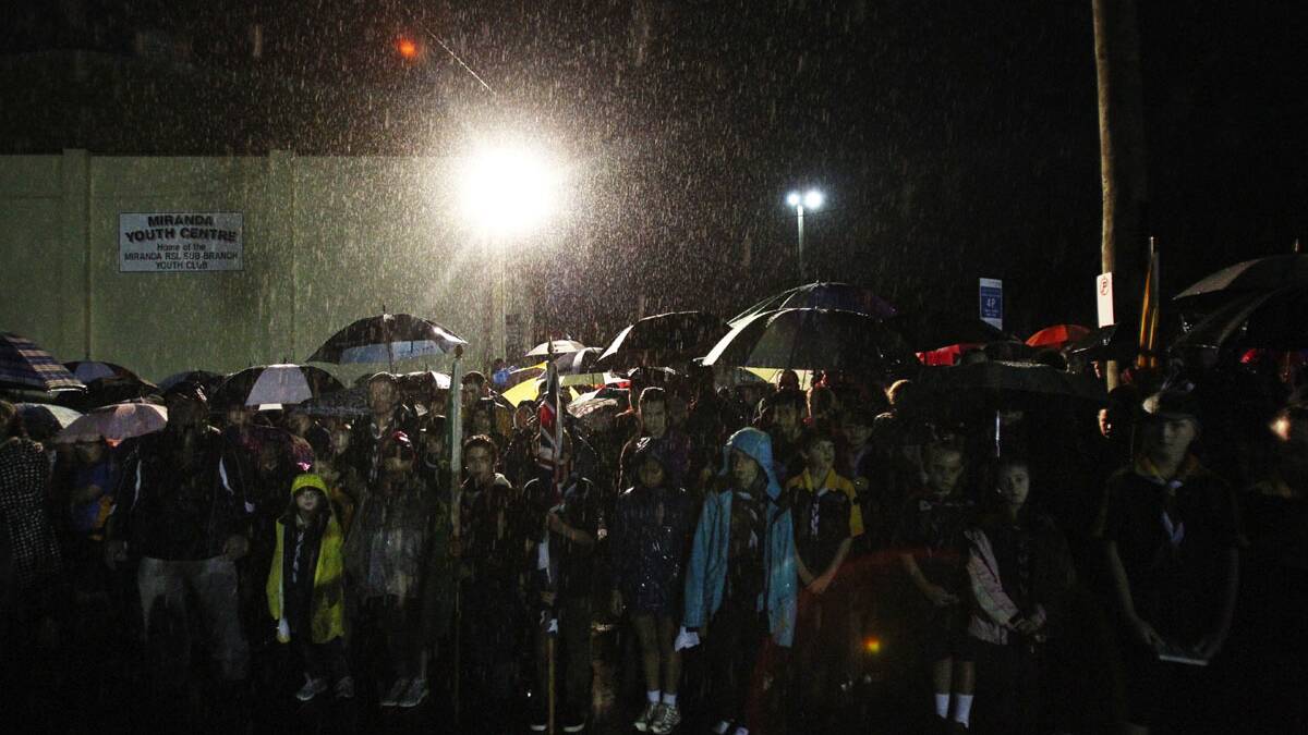 Crowds get wet at the Anzac Day dawn service held by Miranda RSL at the Anzac memorial.Picture Chris Lane