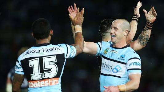 Winners: Cronulla halfback Jeff Robson (right) congratulates Ben Barba after the Sharks brave 24-18 win over North Queensland. Picture: NRL.com.